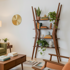 Modern living room with a green sofa, wooden coffee table, and decorative shelf.