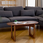 Living room with a dark gray sectional sofa and wooden coffee table.